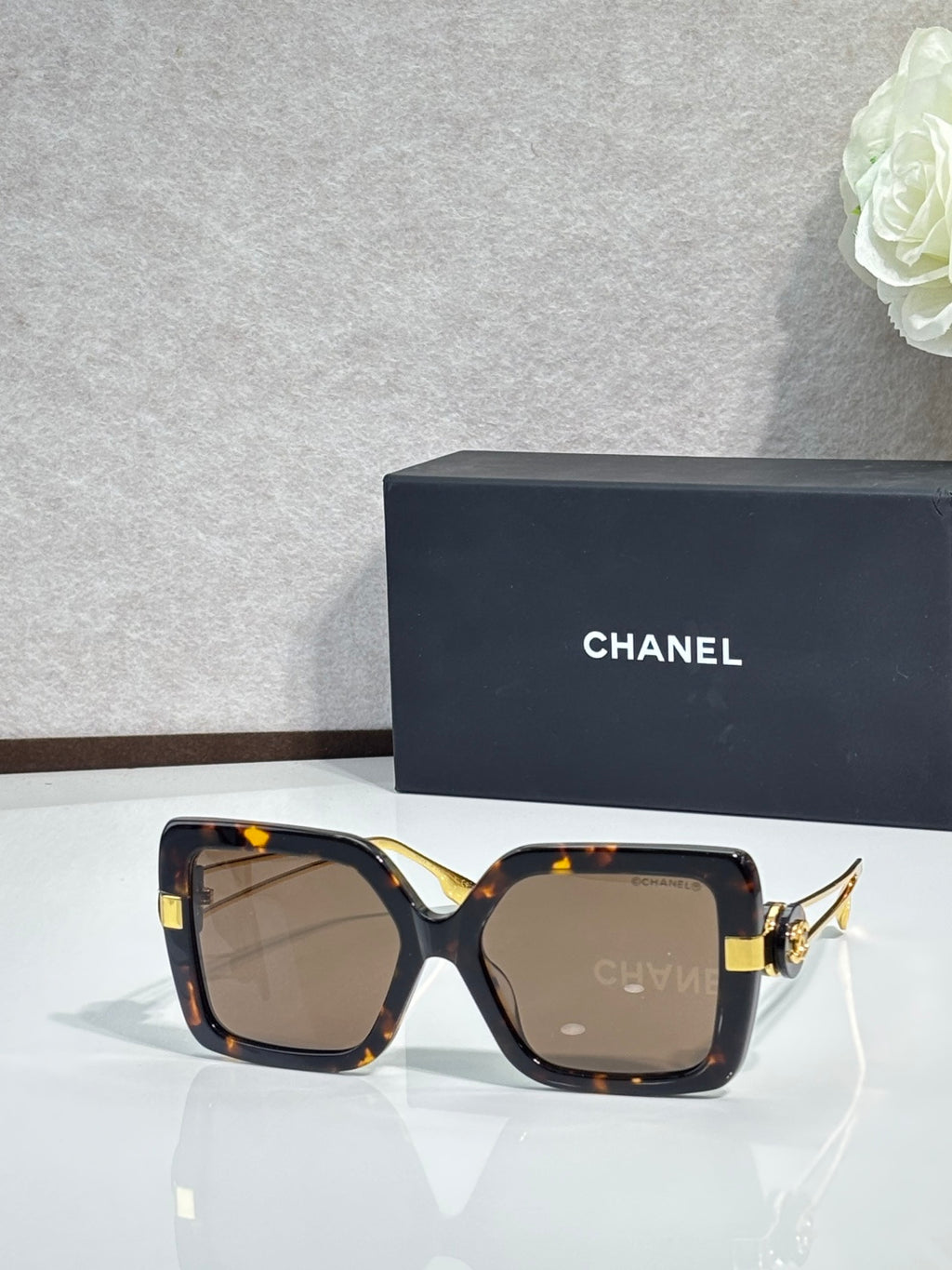 Chanel square sunglasses with dark tortoiseshell frames and gold-tone hinges