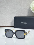 Chanel square sunglasses with black frames and gold-tone hinges