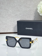 Chanel square sunglasses with black frames and gold-tone hinges