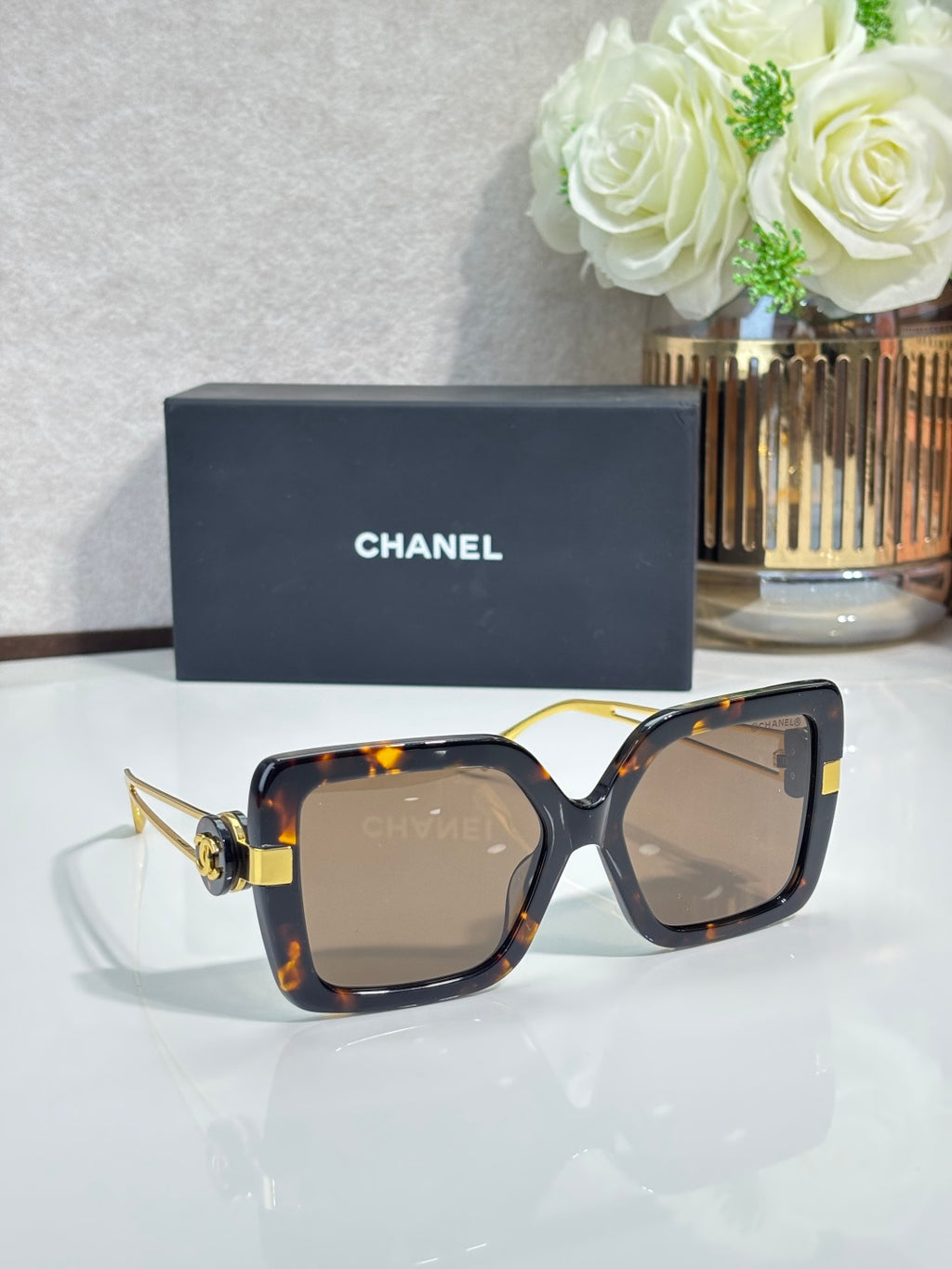 Chanel square sunglasses with tortoiseshell frames and gold-tone temple details