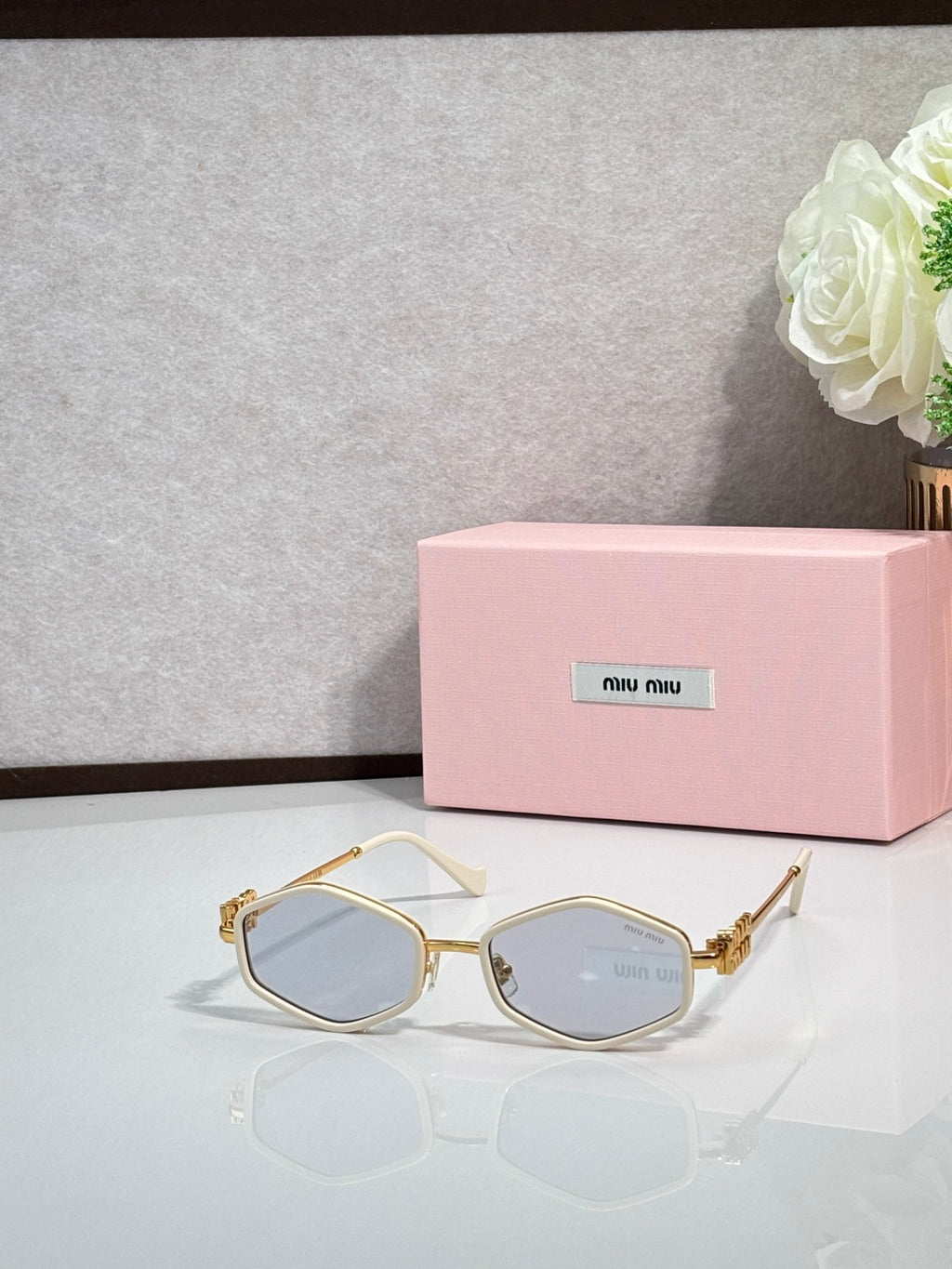 MiuMiu gold octagonal sunglasses with blue-tinted lenses and metal arms