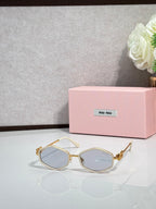MiuMiu gold octagonal sunglasses with blue-tinted lenses and metal arms