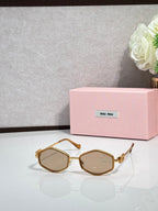 MiuMiu gold octagonal sunglasses with brown-tinted lenses and metal arms