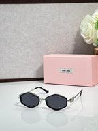 MiuMiu black octagonal sunglasses with dark lenses and metal arms