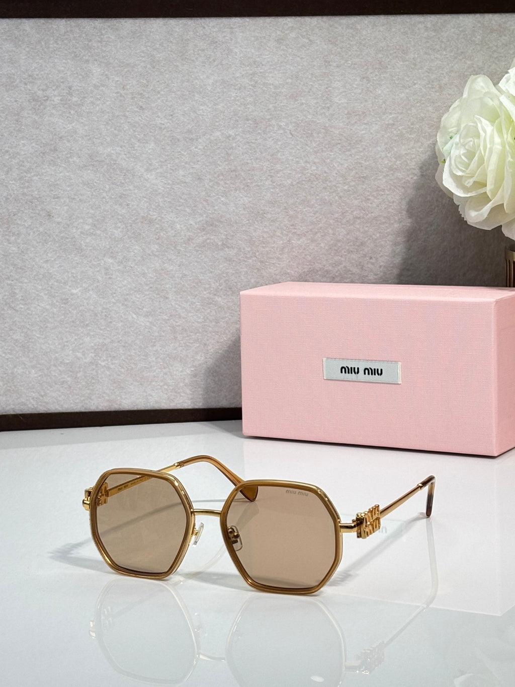 Square sunglasses with gold frame and tan-tinted lenses, metal temple detail