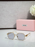Square sunglasses with light-colored frame and pale blue tinted lenses, gold-toned temples