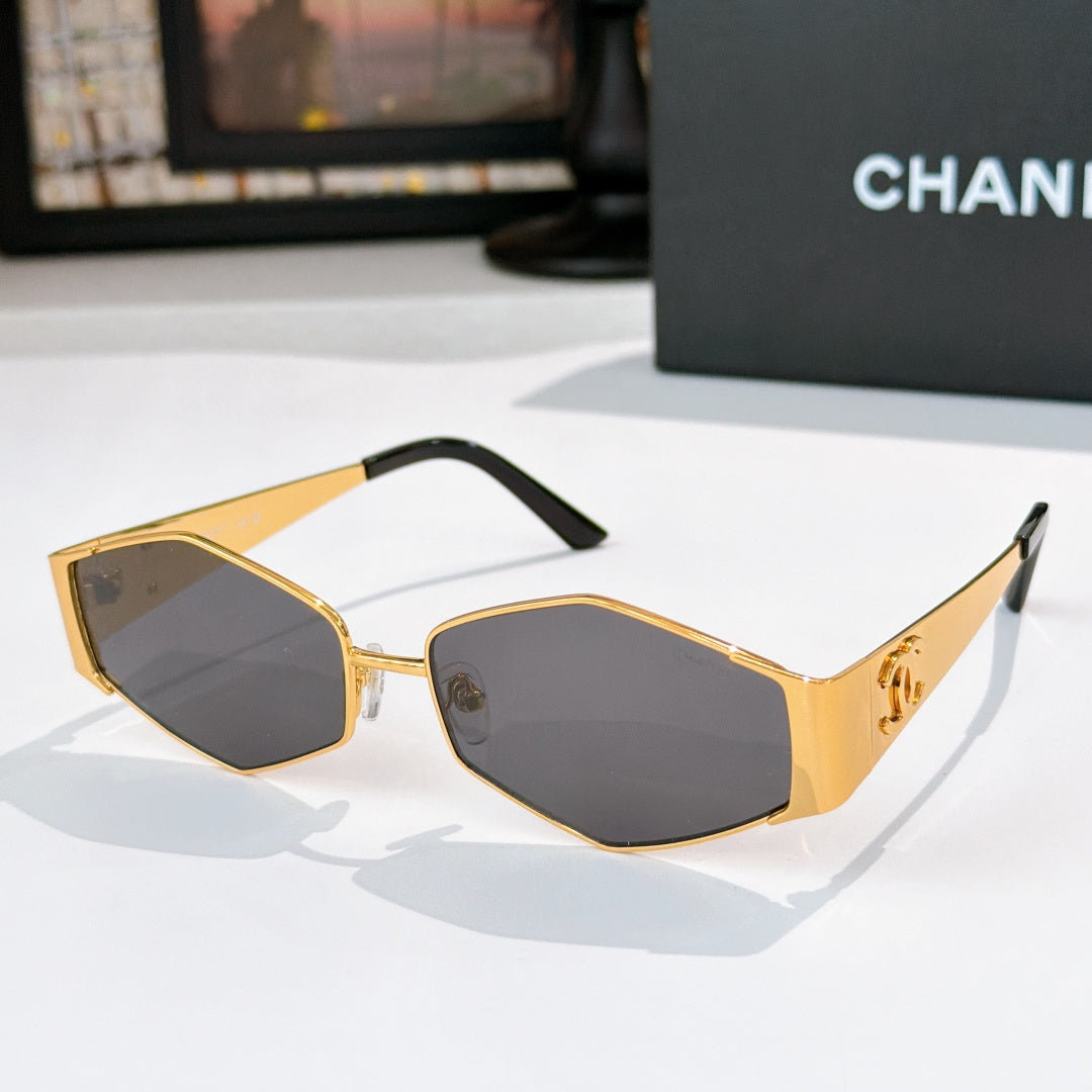Gold-tone hexagon sunglasses with dark lenses and slim metal temples