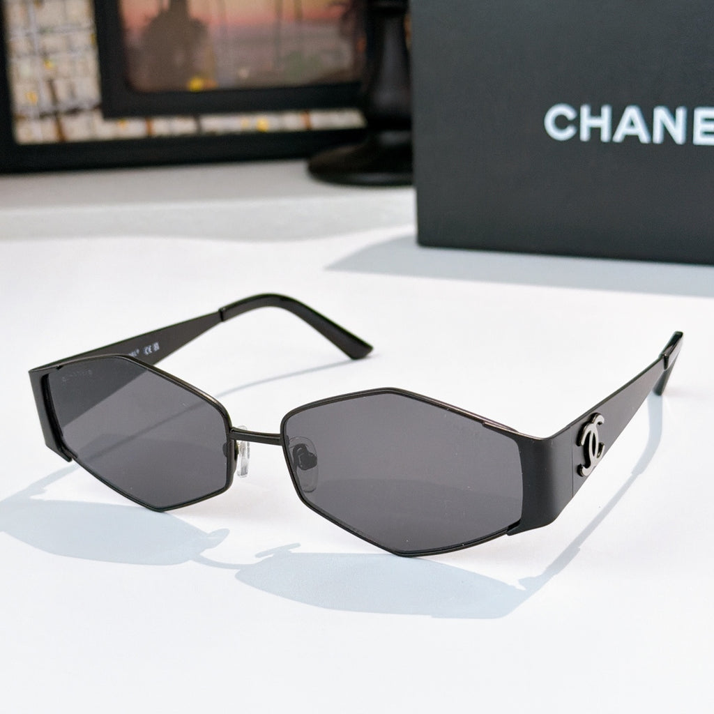 Dark-framed hexagon sunglasses with black-tinted lenses and curved temples