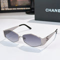Chanel sunglasses with silver frames and dark purple lenses, black temple tips