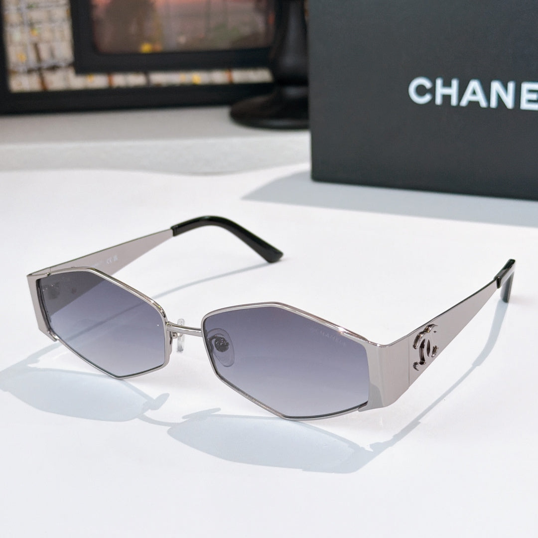 Chanel sunglasses with silver frames and dark purple lenses, black temple tips