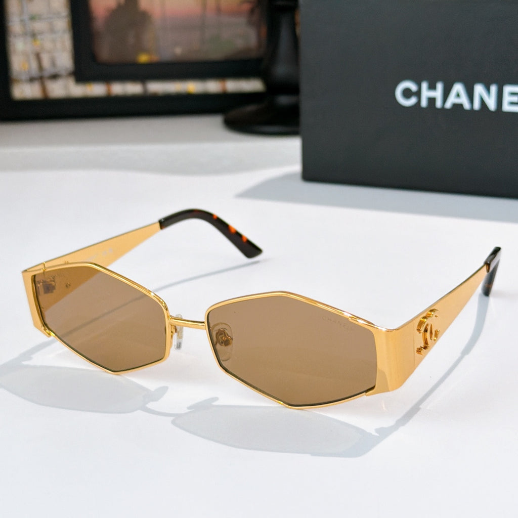 Gold-tone hexagon sunglasses with amber lenses and black temple accents