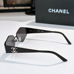 Black hexagon sunglasses with dark lenses and Chanel logo on the temple