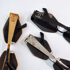 Sunglasses display with black, gold, and silver frames and dark tinted lenses