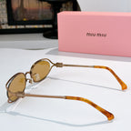 MiuMiu sunglasses with small oval gold frames, amber lenses, orange translucent temple arms