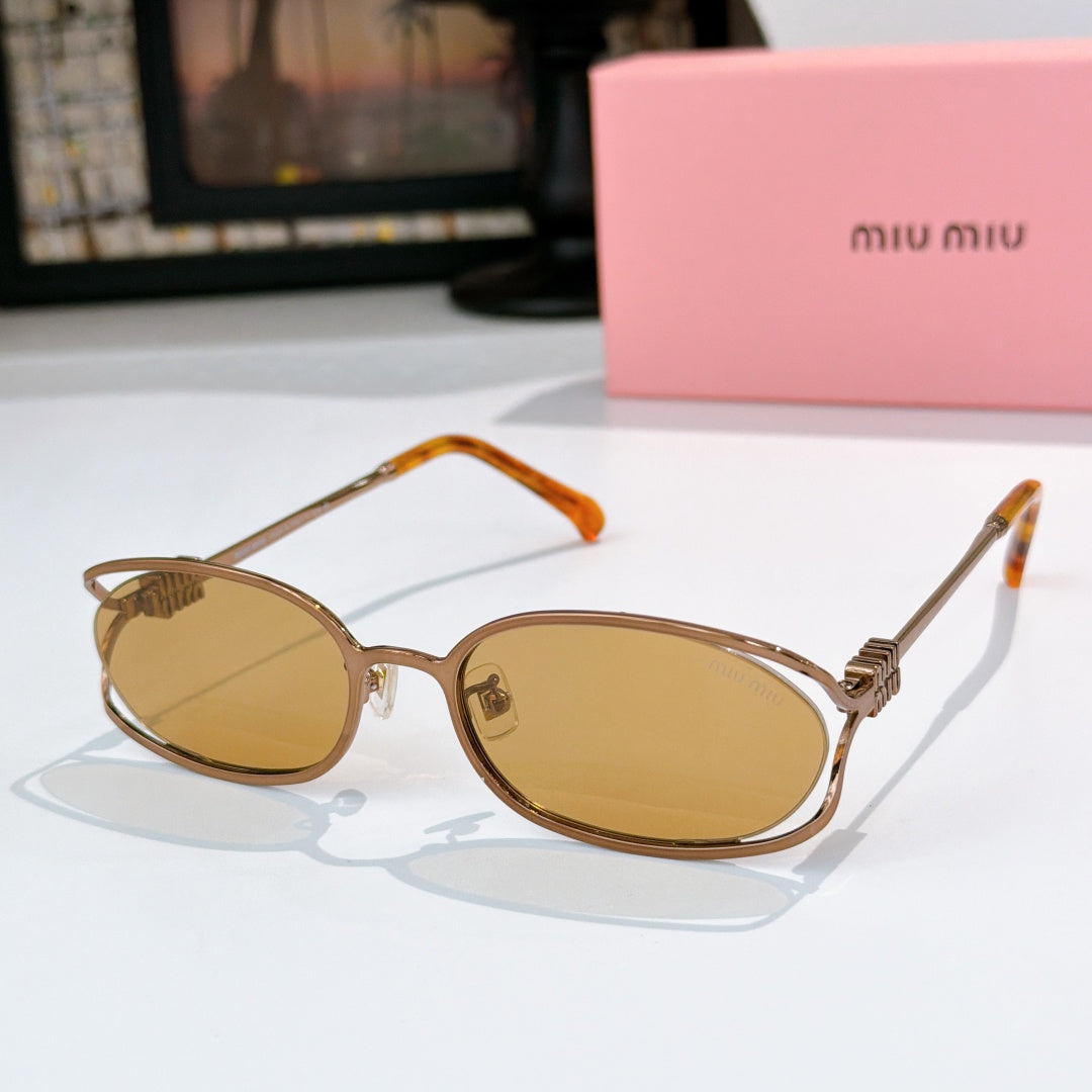 MiuMiu sunglasses with gold-tone oval frames and amber lenses, orange-tinted temple arms