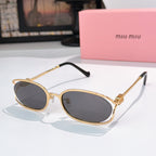 MiuMiu sunglasses with gold-tone oval frames and dark gray lenses, black temple arms