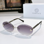 Round sunglasses with purple lenses, gold frame, and textured arms with charms