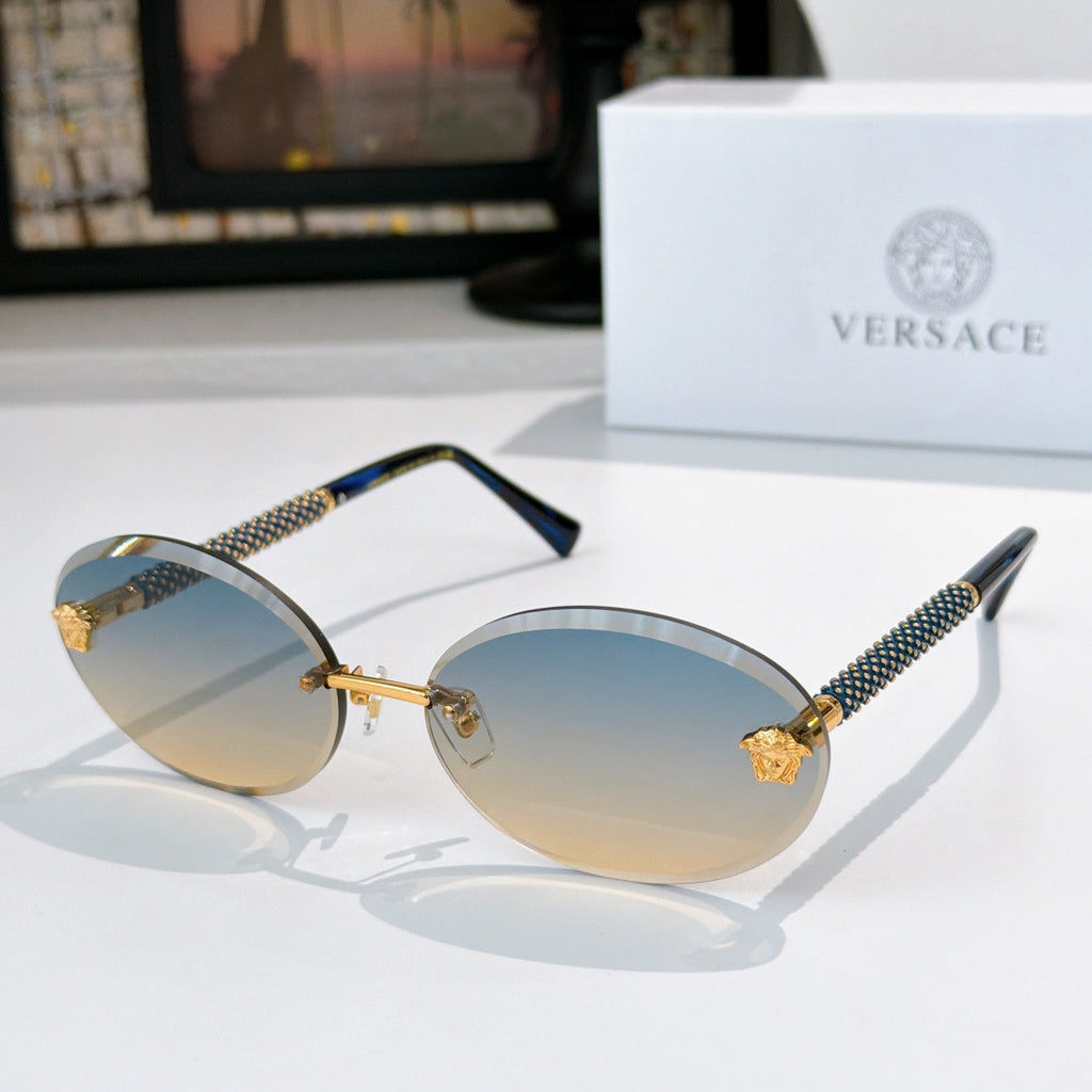 Round sunglasses with light blue lenses, gold frame, and textured arms with charms