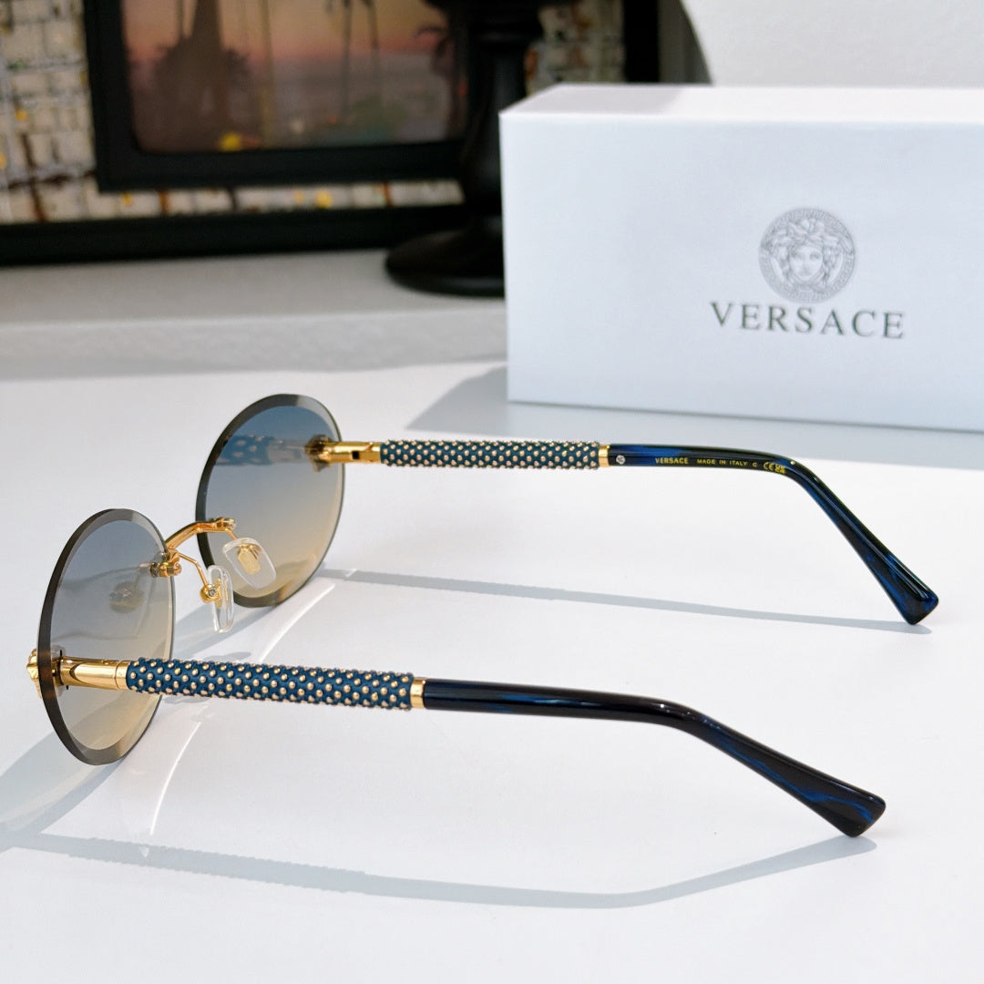 Round sunglasses with blue-tinted lenses, gold frame, and textured temples in dark blue