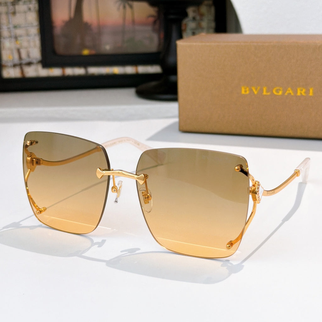 Gold gradient sunglasses with gold-tone frames and angular cat-eye shape