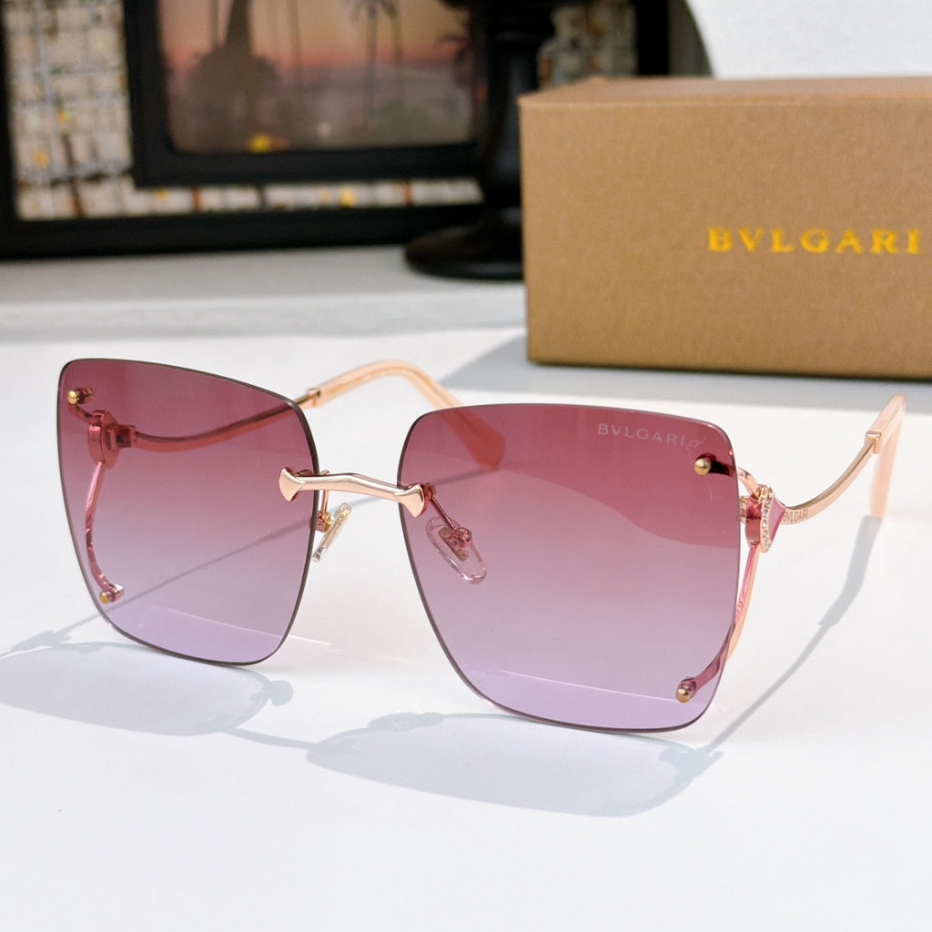 Pink gradient sunglasses with gold-tone frames and red temple accents