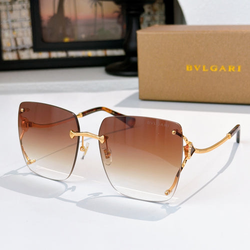 Amber gradient sunglasses with gold-tone frames and angular cat-eye shape
