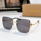 Gray gradient sunglasses with gold-tone frames and angular cat-eye shape