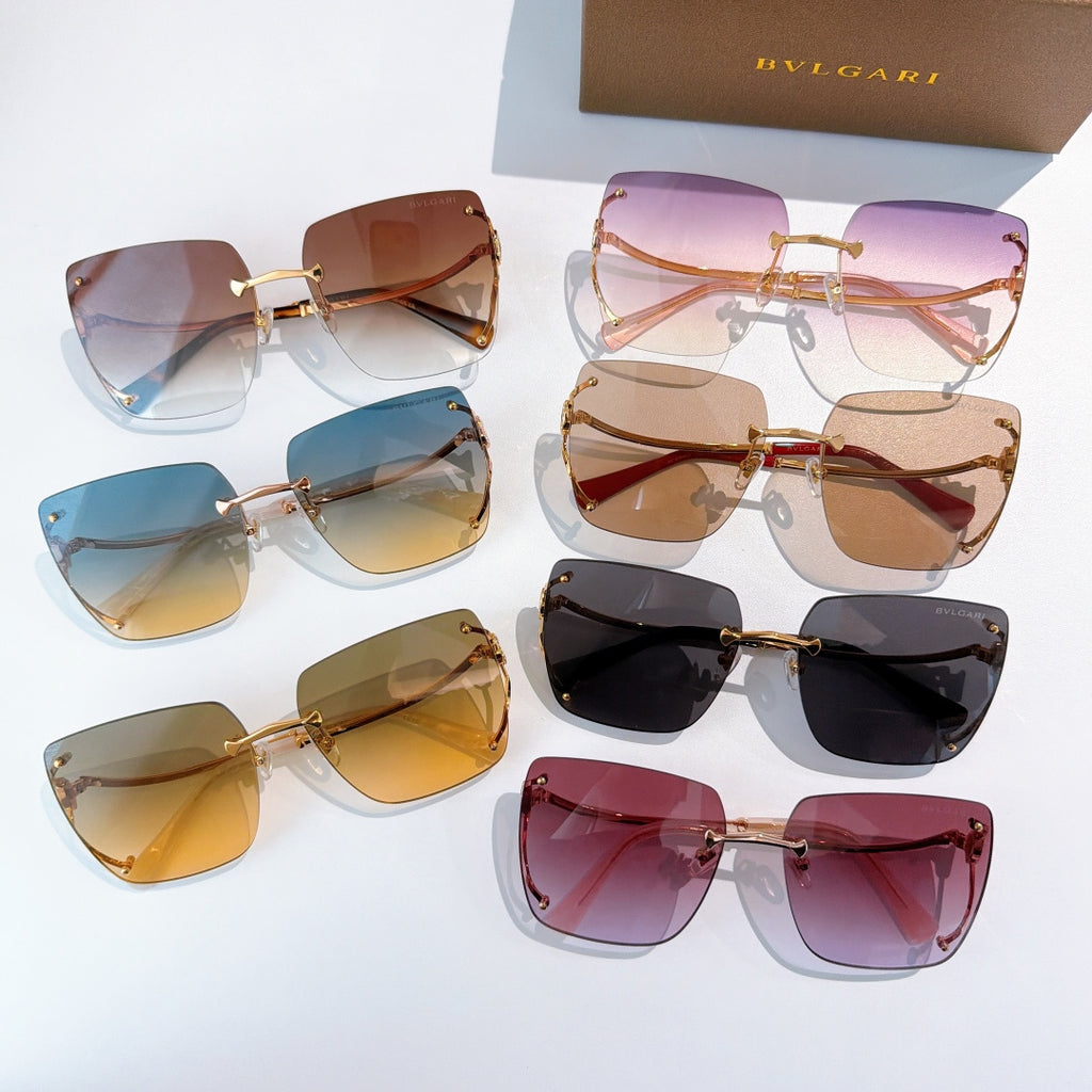 Assorted gold-tone sunglasses with gradient lenses, multiple pairs on display