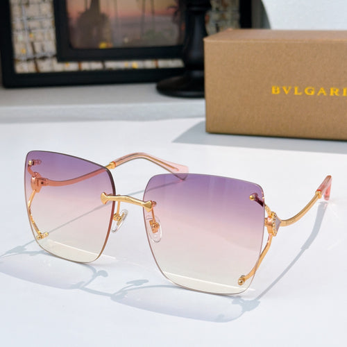 Purple gradient sunglasses with gold-tone frames and angular cat-eye shape