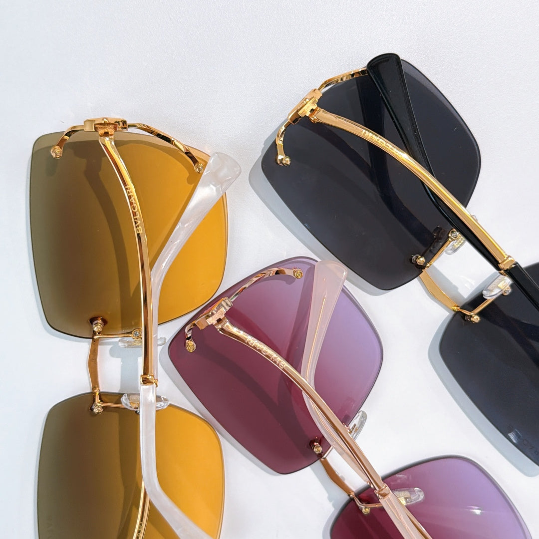 Gold-trim sunglasses with assorted gradient lenses, shown in close-up