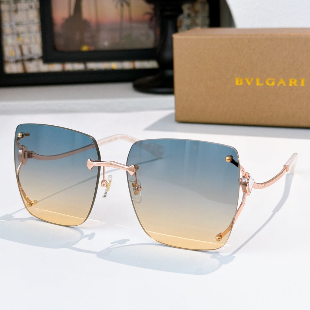 Blue-to-yellow gradient sunglasses with gold-tone frames and angular cat-eye shape