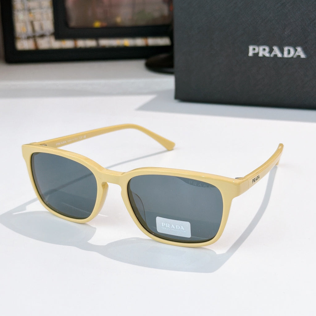 Prada sunglasses with light yellow frame and blue-tinted lenses
