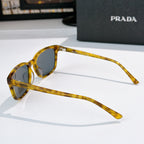 Prada sunglasses with amber frame shown in side view