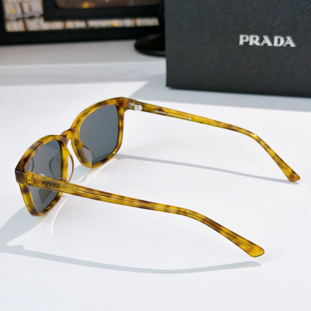 Prada sunglasses with amber frame shown in side view