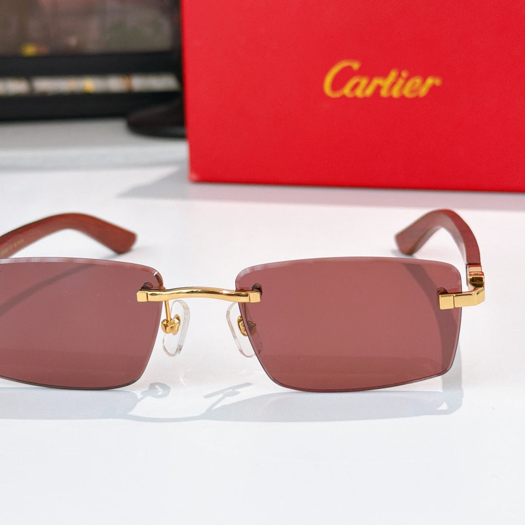 Cartier sunglasses close-up with mauve-brown lenses and gold-tone metal bridge
