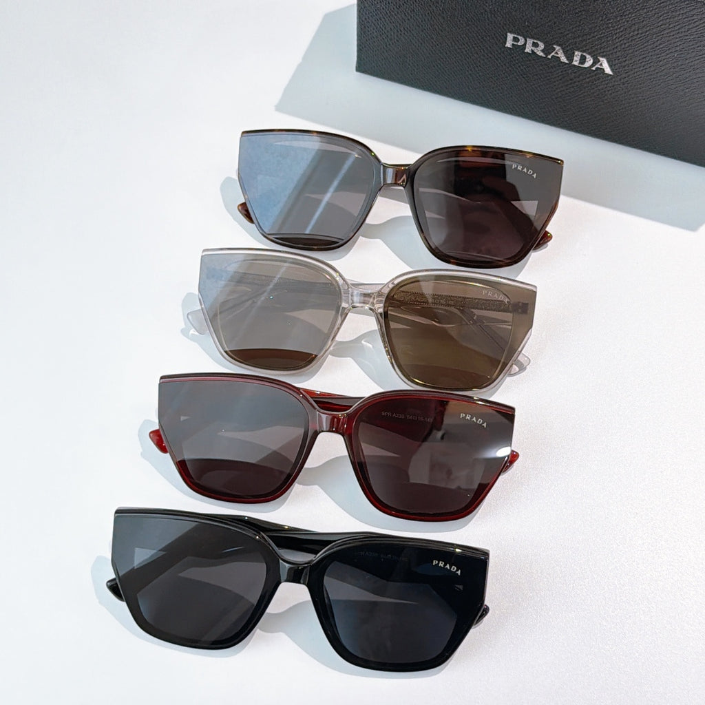 Prada sunglasses assortment with mixed frames and tinted lenses, multiple pairs