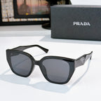 Prada sunglasses with black frames and dark lenses, cat-eye silhouette