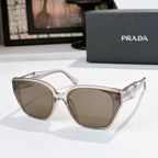 Prada sunglasses with clear frames and taupe lenses, cat-eye shape