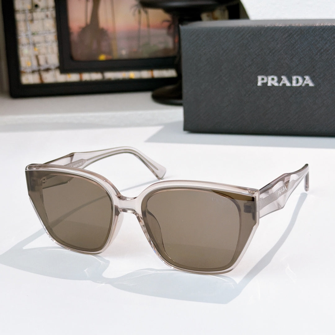 Prada sunglasses with clear frames and taupe lenses, cat-eye shape