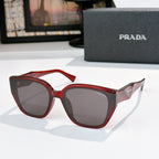 Prada sunglasses with red frames and dark lenses, cat-eye style