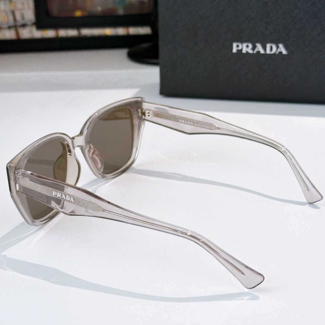 Prada sunglasses side view with clear frames and brown tinted lenses