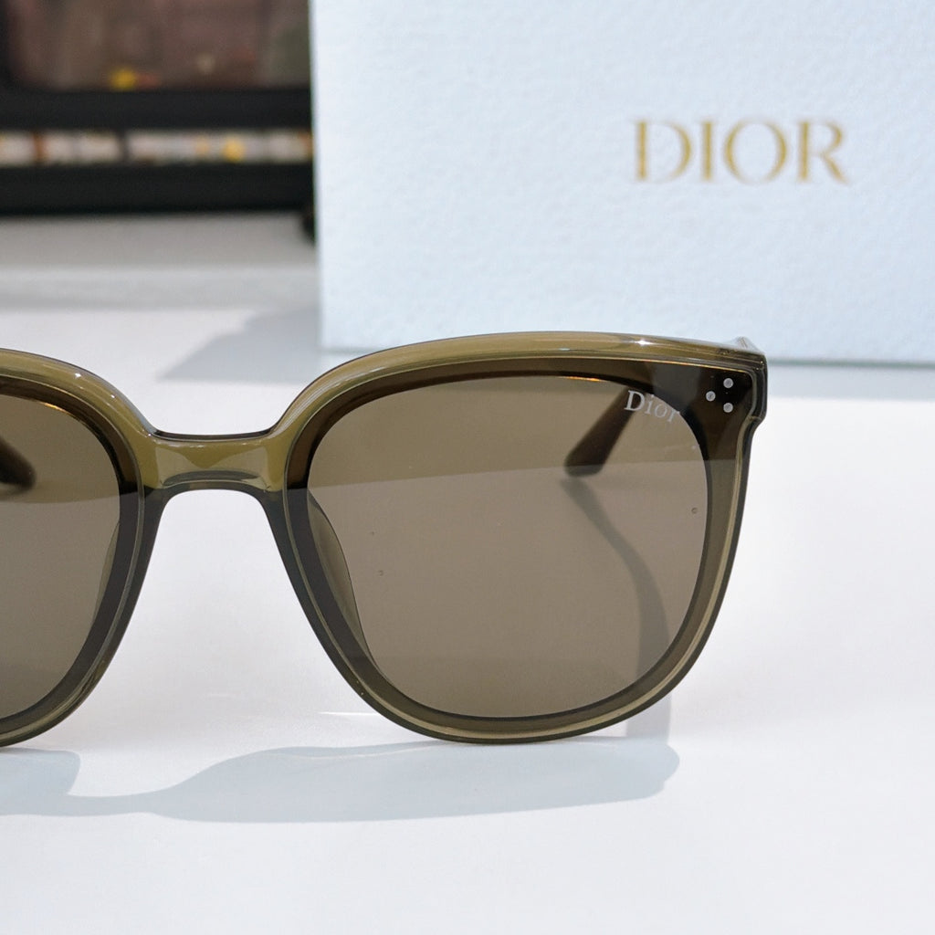 Dior sunglasses close-up with olive frame and dark brown tinted lenses