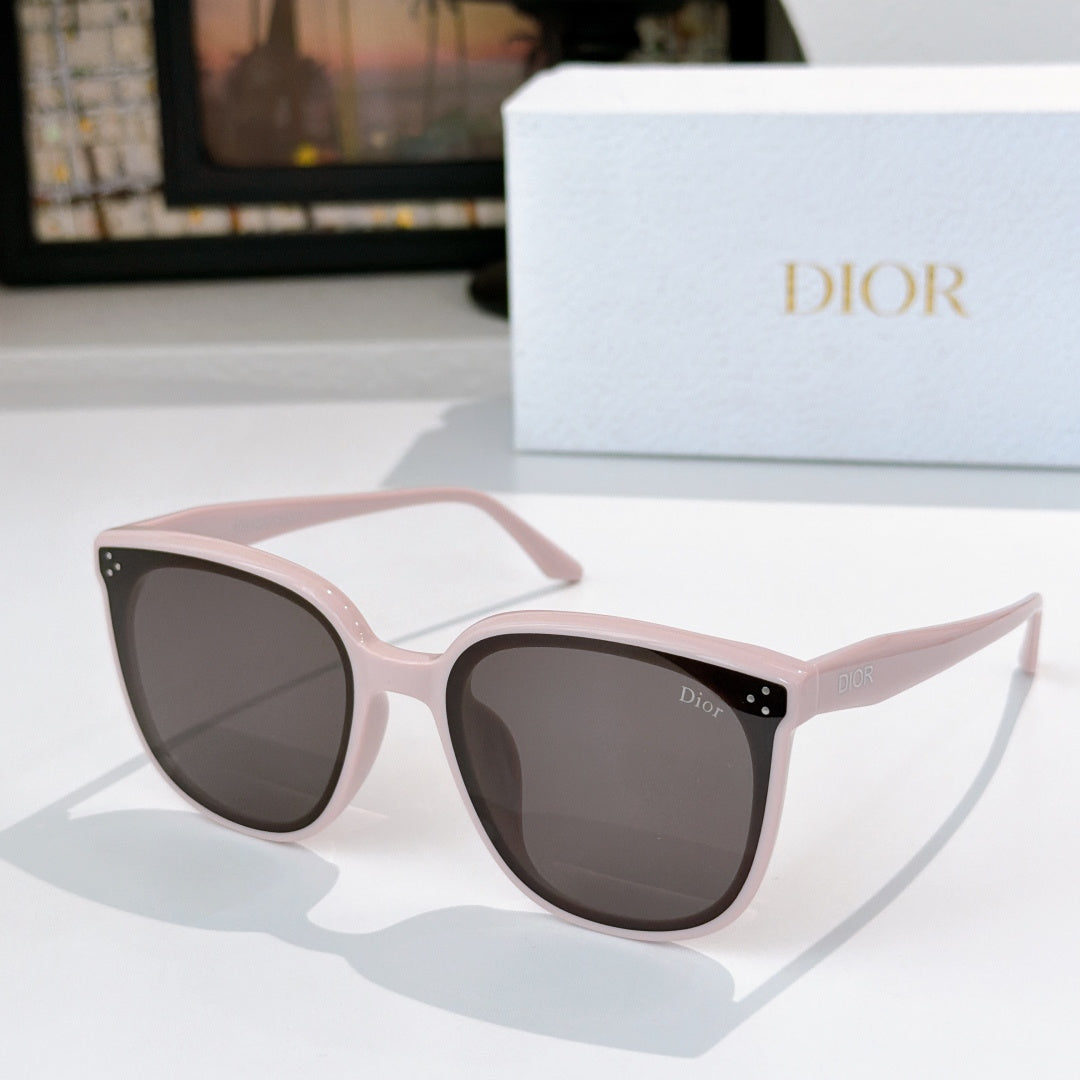 Dior cat-eye sunglasses with light pink translucent frame and dark lenses