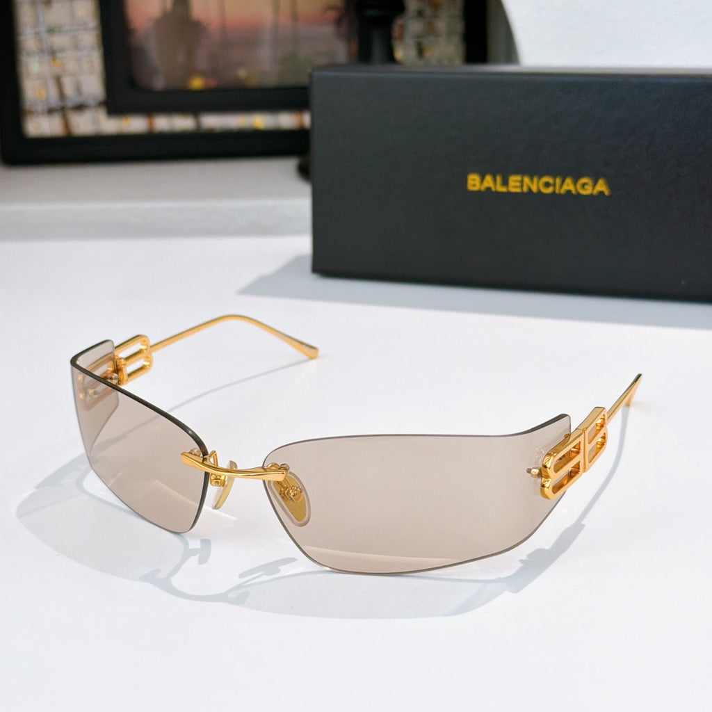 Sunglasses with beige-tinted lenses and gold metal frame, logo panel on arms