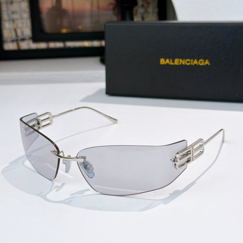 Sunglasses with pale blue lenses and silver metal frame, detailed temple logo