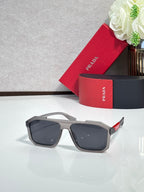 Oversized rectangular sunglasses with gray frame and dark lenses, Prada temple logo