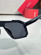 Black rectangular sunglasses with dark lenses and Prada logo on temple