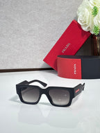 Black oversized sunglasses with dark lenses and small logo on the arm