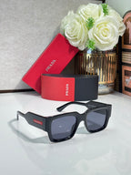 Black oversized sunglasses with dark lenses and Prada logo on the temple