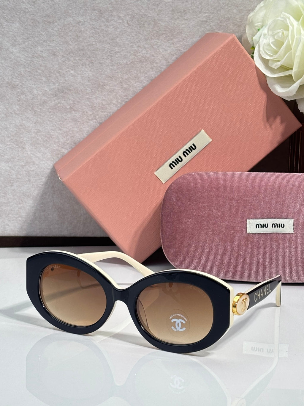 Designer round sunglasses with white frame and brown tinted lenses